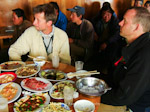 Charles Kilner & Simon Mills watch TV in a truck stop, Chinese style. Sichuan.